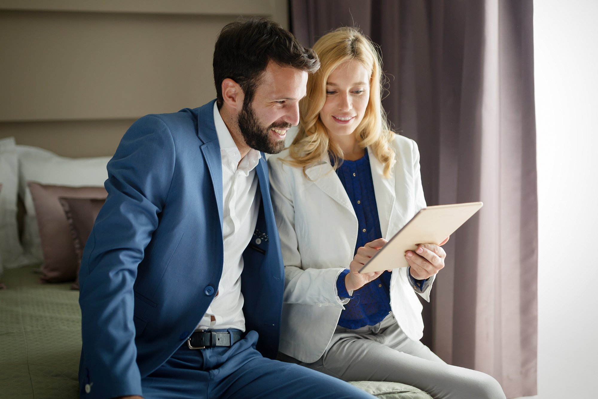 attractive-man-and-beautiful-woman-using-tablet-2025-03-14-02-12-11-utc