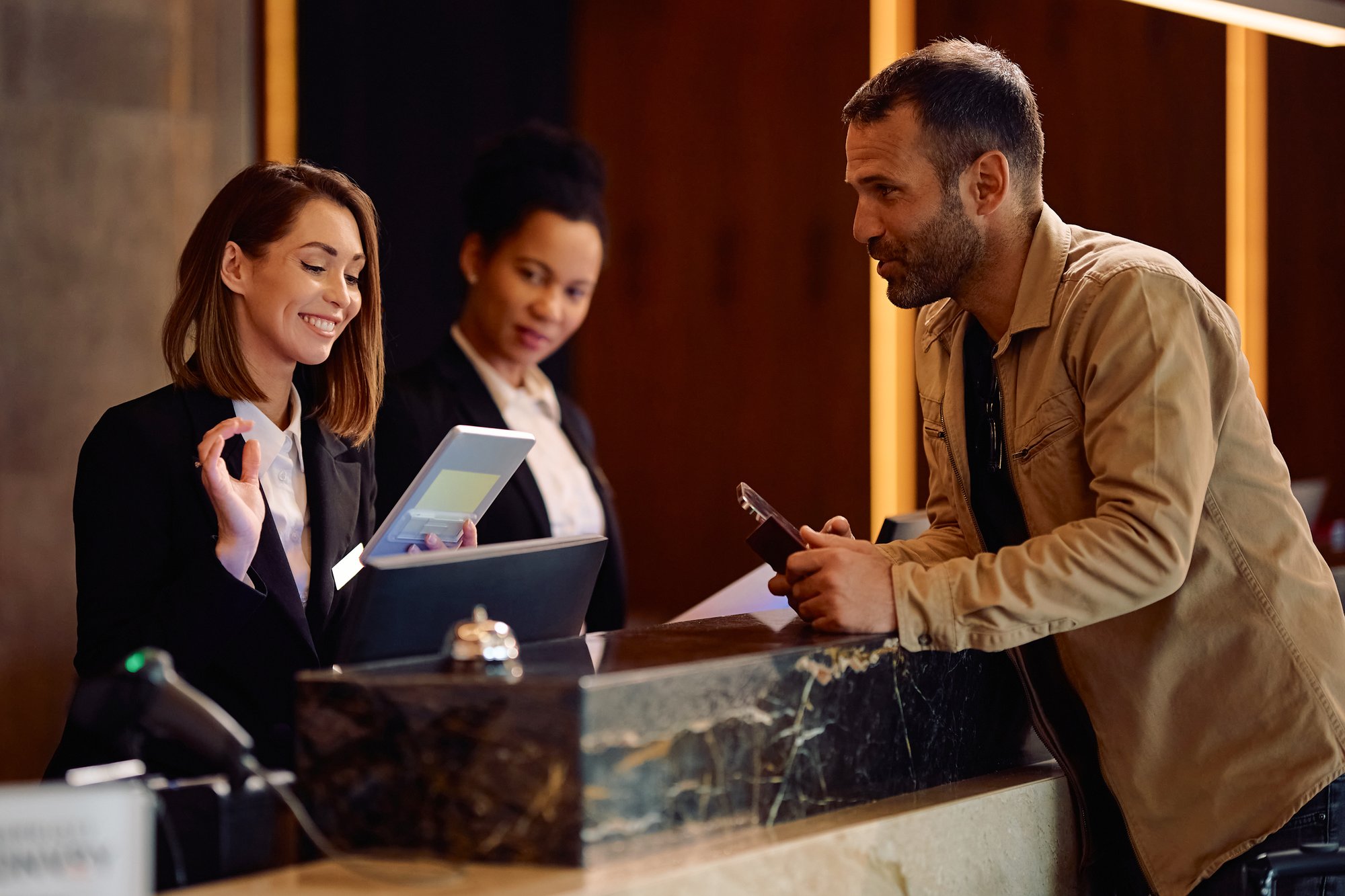 happy-female-receptionist-using-touchpad-while-wel-2025-08-18-13-42-45-utc